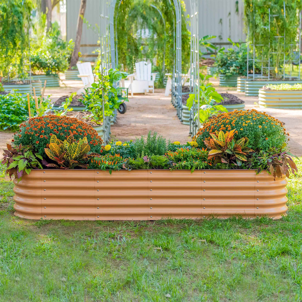 A terracotta-finish modular metal raised garden bed planted in a garden
